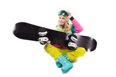 白色迷人的年轻白人女孩穿着五颜六色的滑雪服蓝色雪地靴和黄色裤子图片