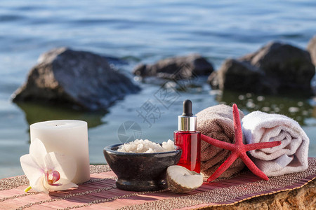 海盐碗芳香油瓶蜡烛海贝壳海星和毛巾图片