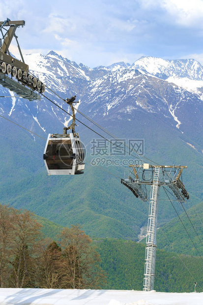 在绿色森林和山岳的背景下在雪滑赛道上图片