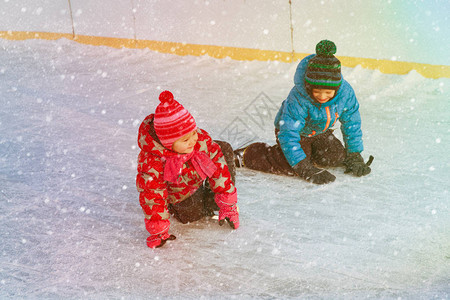 快乐的小男孩女学习滑冰孩背景图片