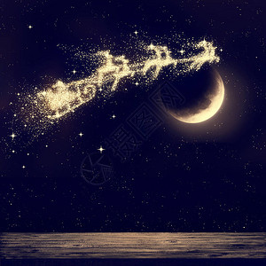 圣诞老人在月光下在夜空中飞翔图片
