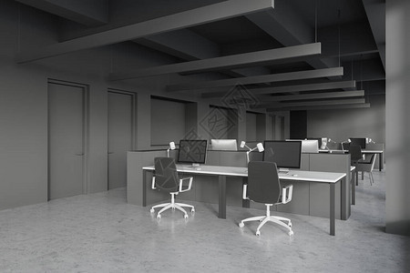 开放空间办公室的内部有灰色的墙壁混凝土地板和一排白色的电脑桌图片