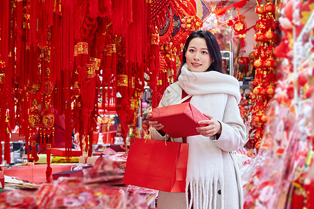 买新年年货的女子手拿礼物盒图片