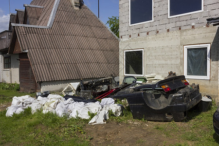 农村垃圾场拆卸的汽车和垃圾袋阳光灿图片