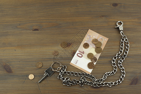 房子钥匙和木桌上的小零钱图片
