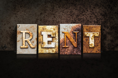Rent这个词是用生锈的金属纸质印刷写在暗背景图片
