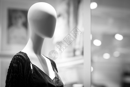 在百货商店小窗户上装饰着女时尚服装的女店铺背景图片