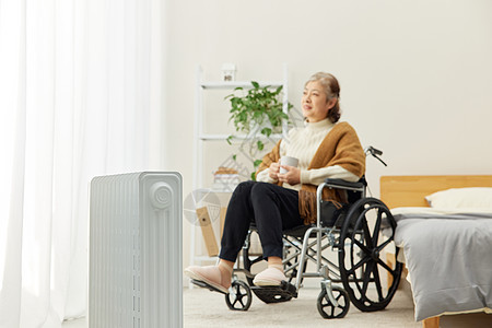 坐轮椅的奶奶居家使用移动暖气片图片