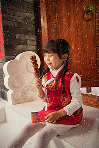 糖葫芦元素吃糖葫芦的小女孩背景