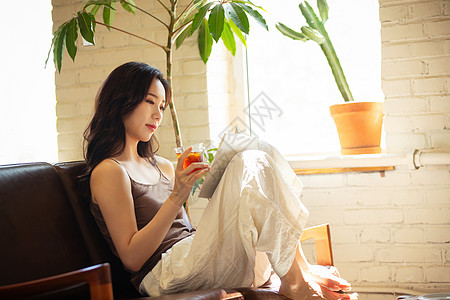 年轻女人在家喝茶看书图片
