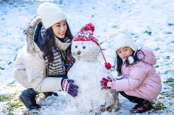 快乐的母女推雪人图片