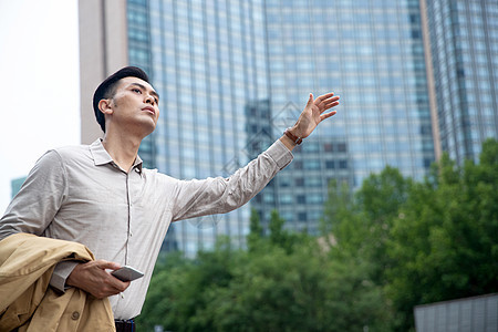 商务男士在商业区拦出租车图片