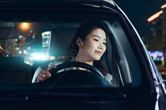 夜晚驾驶汽车的青年女人图片