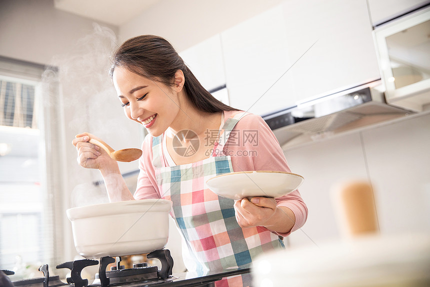 青年女人在厨房煲汤图片