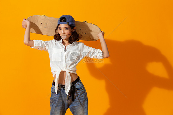 年轻女孩拿着滑板图片