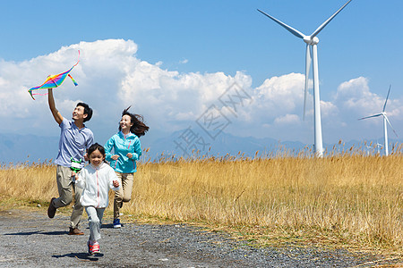 风车草地快乐家庭在户外郊游背景