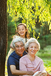 老年夫妇带着孙女在公园里郊游图片