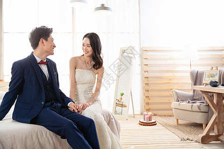 年轻人,西装新婚夫妇坐在床上聊天背景