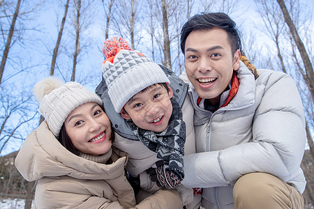 在雪地上玩耍的一家三口图片