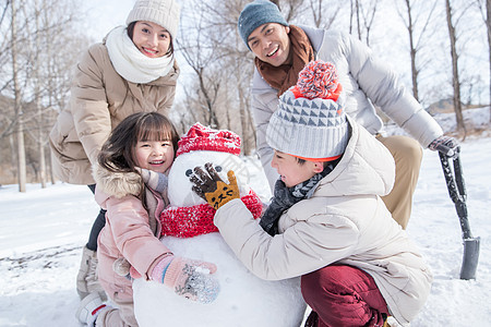 欢乐家庭在雪地里堆雪人图片