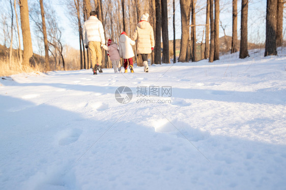 快乐家庭在雪地里散步图片