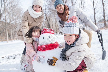 欢乐家庭在雪地里堆雪人图片