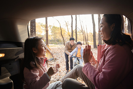 幸福母女在车中游戏快乐父子在学自行车图片