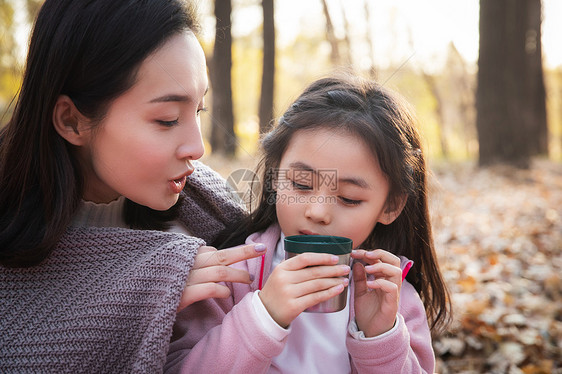 秋天户外幸福的母女在喝水图片