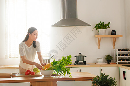 青年女人在厨房里做饭图片