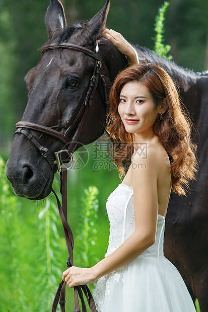 草丛中漂亮的年轻女人和马图片