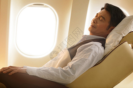 商务男士在飞机上睡觉背景