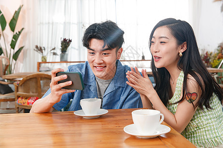 青年情侣在家玩手机图片