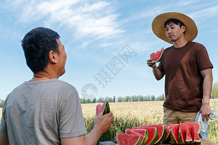 农民在田地旁休息吃西瓜图片