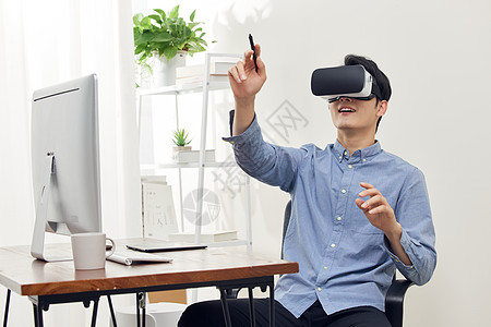 3d建模办公室使用vr眼镜的男性操作虚拟屏幕背景