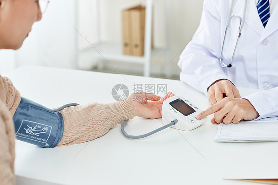老人医院检查身体量血压特写图片