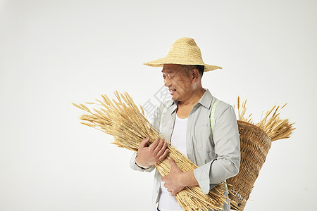 淳朴农民抱着稻谷形象图片