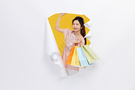 创意女性购物手拿购物袋背景图片