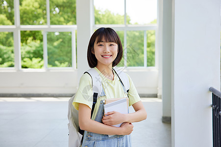 拿着书本的女大学生形象图片