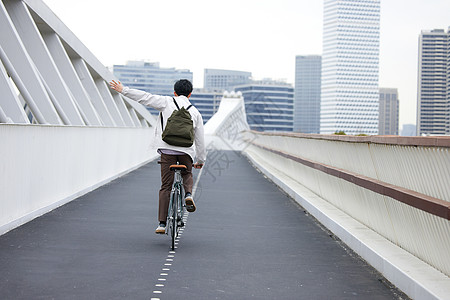 年轻男性都市骑自行车通勤背影背景