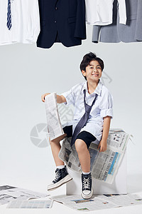 坐在椅子上手拿报纸的商务男孩形象图片