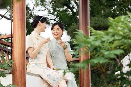 院子里喝茶聊天的旗袍母女背景图片