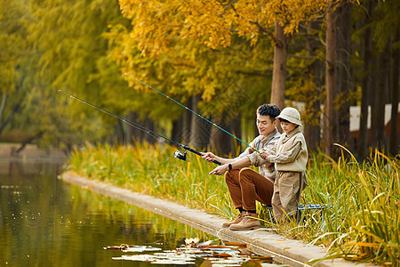 秋游湖边钓鱼的父子形象背景图片
