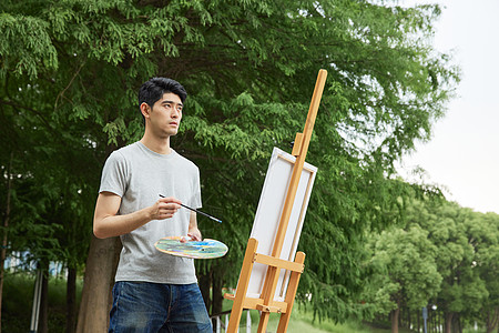 青年节户外画画写生的男性背景