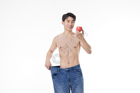 肌肉男性手拿苹果背景图片