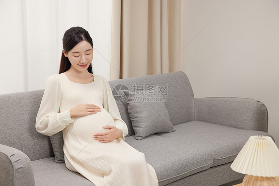 在客厅沙发上休息的孕妇图片