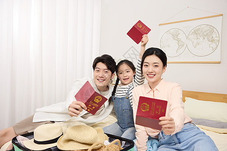 父母旅游一家三口正向镜头展示护照背景