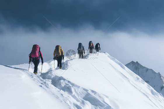 登山者爬上一座雪山图片