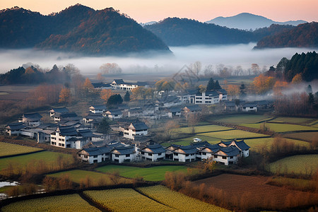 山脉下的田园村庄风景图片