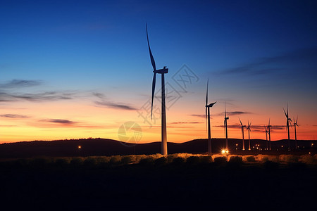 日落时风力发电机景观图片