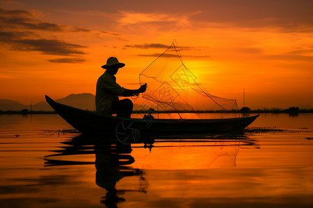 日落时湖中渔船上的农民图片